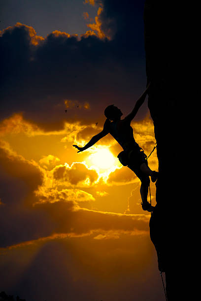 istock Elegant female climber silhouette against sunset 510741345