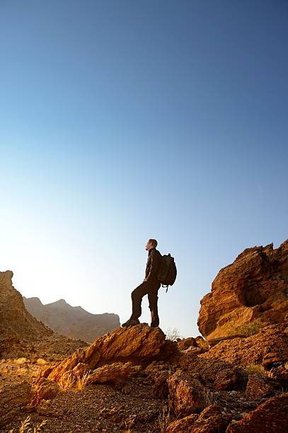 istock Man watching a sunrise over desert scene portrait 510741505