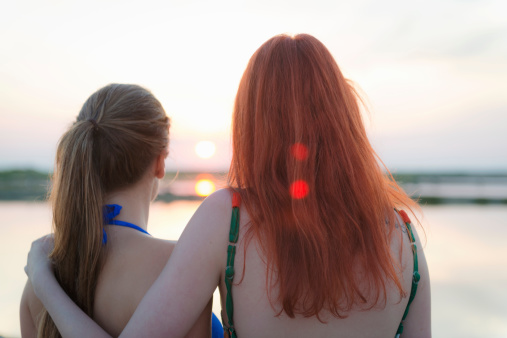 Female teenagers during summer vacations on the Adriatic coast, sunset, Slovenia,  Europe.