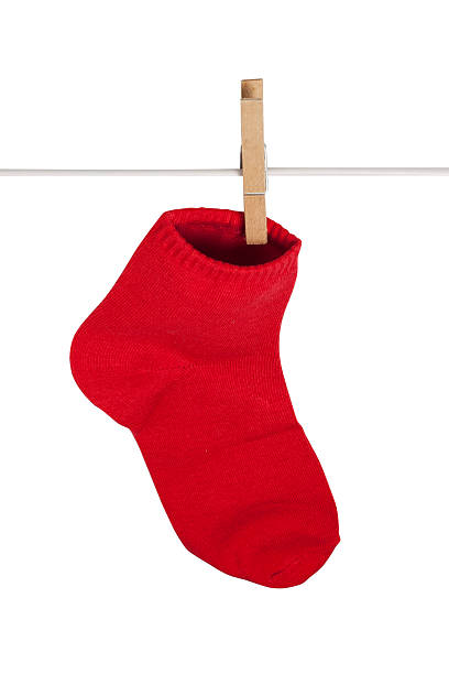 istock Red Sock hanging with clothespins 510744059
