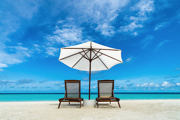 istock Beach lounger and umbrella on sand beach. 510763497