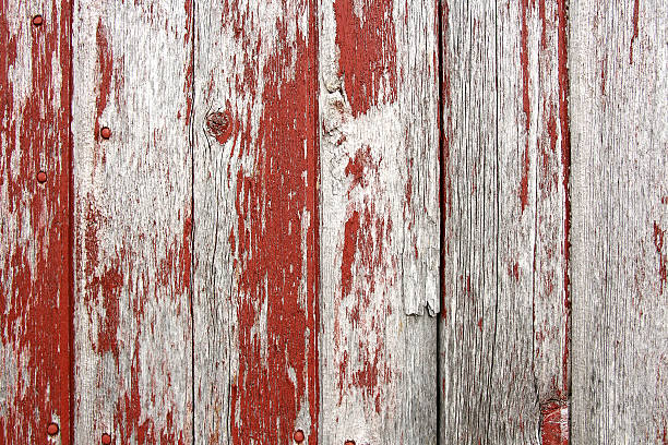 Red Rustic Barn Wood Background A background of rustic, aged barnwood boards, with peeling red paint. knotted wood wood dirty weathered stock pictures, royalty-free photos & images