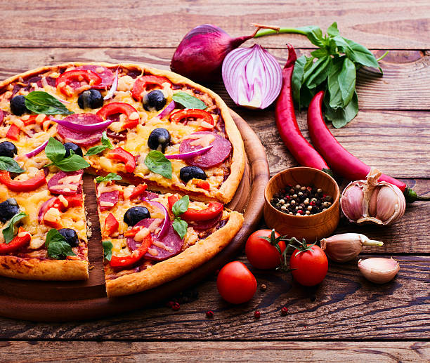 istock Pizza with ham, pepper and olives. 510768683
