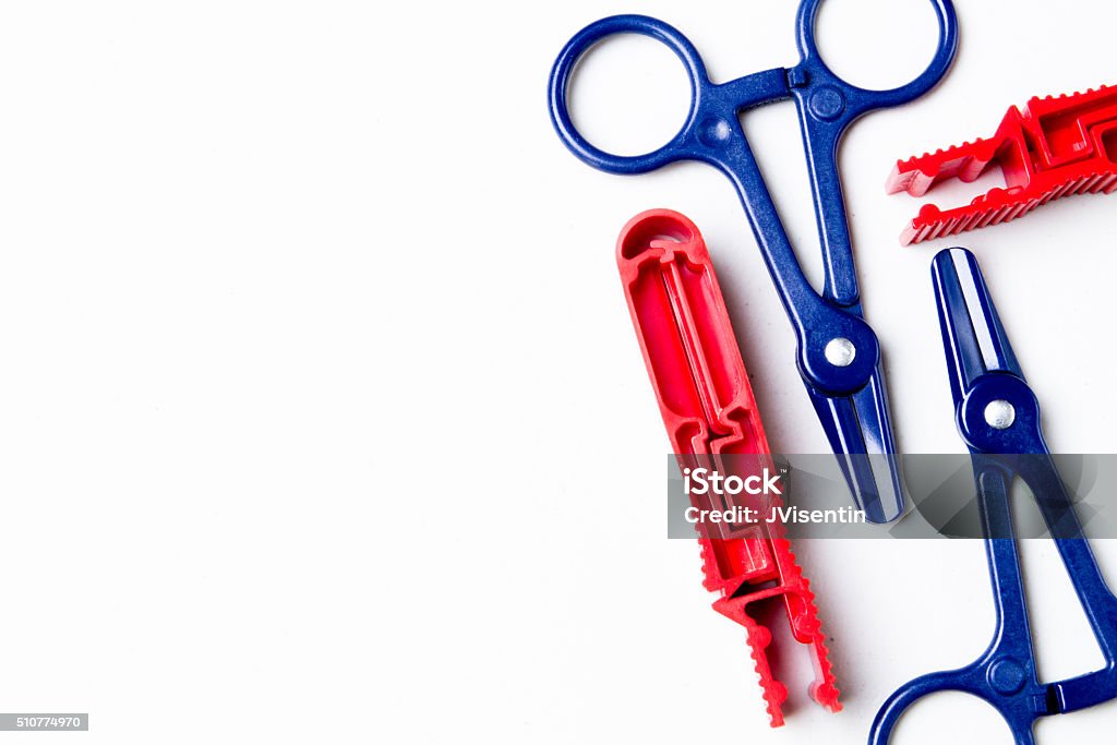 Red and Blue Clamps Clamps used in peritoneal dialysis transfers. Peritoneal Dialysis Stock Photo