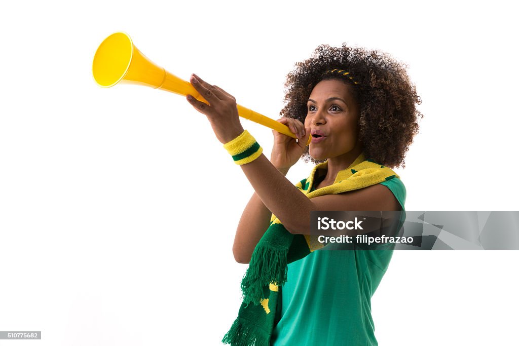 Brazilian woman blowing by vuvuzela on white background Brazilian sport collection American Football - Ball Stock Photo