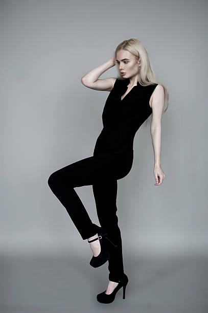 istock Blond European model sitting in black costume 510777790