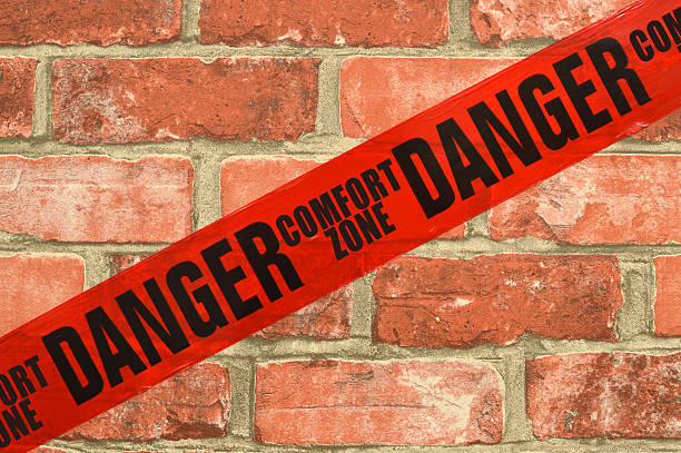 Danger Red Tape Comfort Zone Brick Wall stock photo