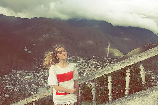 Photo of girl in mountain, view over the town of Banos in Ecuador