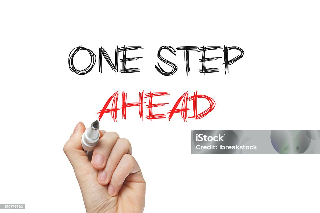 Hand writing one step ahead Hand writing one step ahead on a white board Achievement Stock Photo
