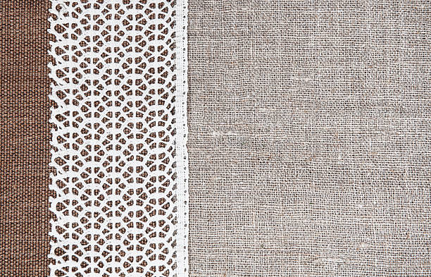 istock Vintage background with rude fabric and lace on burlap 510780464