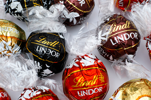 Tambov, Russian Federation - March 08, 2015: Lindt Lindor chocolate truffles on white background. Lindor assorted balls: the Lindt milk, dark and white chocolate candies. Studio shot.