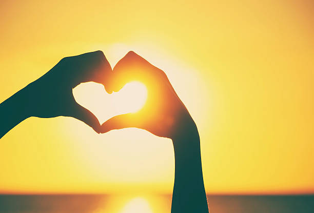 istock Love shape hands silhouette during sunset 510781058