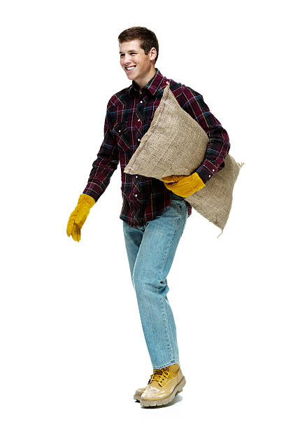 istock Smiling farmer holding sack and walking 510789590