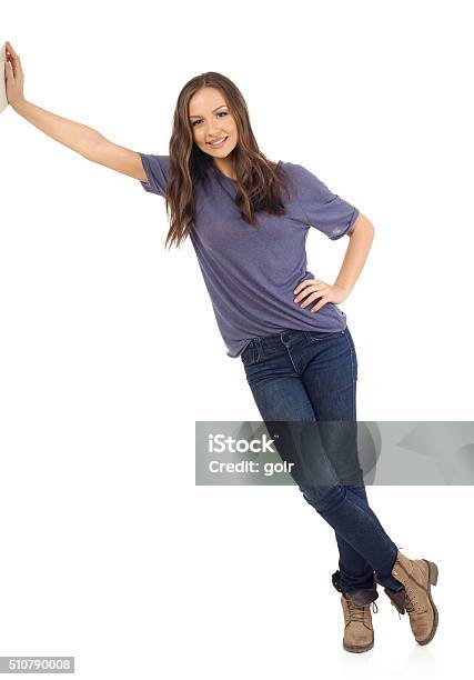 Smiling Girl Lean On Wall Stock Photo - Download Image Now - Leaning, Women, Teenage Girls