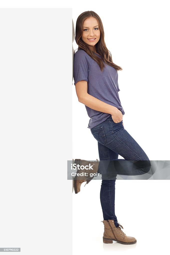 Cheerful young girl Smiling girl lean on wall, white background 20-24 Years Stock Photo