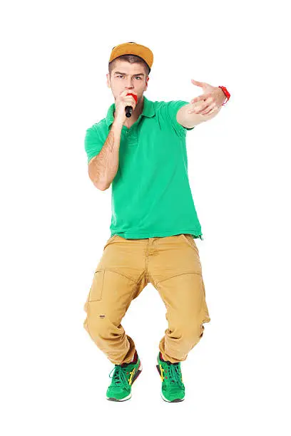 Portrait of young male hip hopper singing in studio isolated on white background.