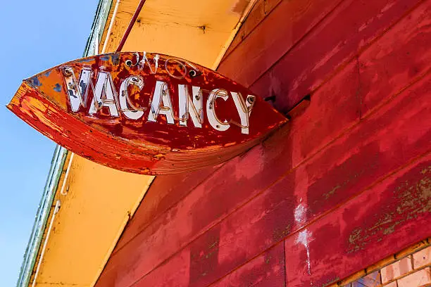 Tucumcari, NM, USA - June 16, 2015: Battered and worn out overhead Vacancy sign at an abandoned Route 66 motel in Tucumcari, New Mexico