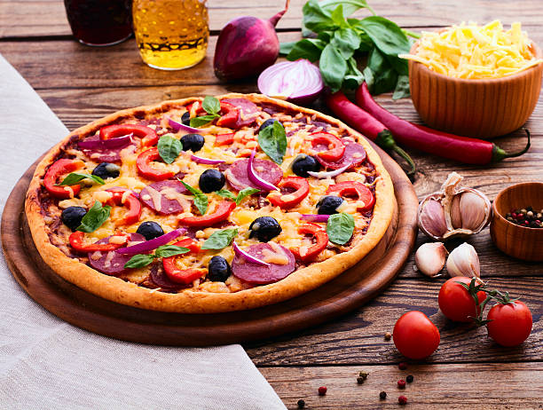 istock Pizza with ham, pepper and olives. 510792527