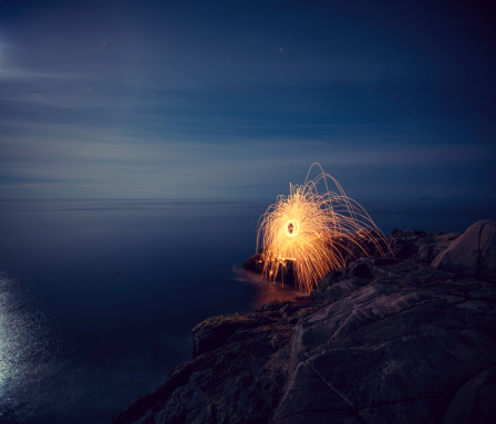 A ball of sparks spins into the Atlantic.  Long exposure in Moonlight.