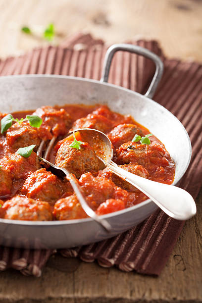 istock meatballs with tomato sauce in pan and spoon 510793977