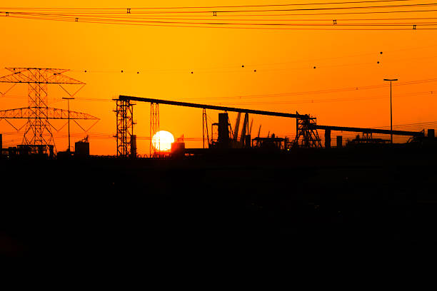 Gorgeous Sunset and heavy engineering project site with electrical pylon.