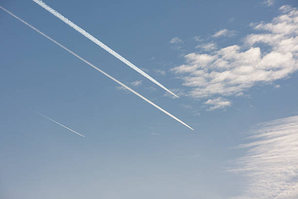 istock Three vapor trails in blue sky over Berlin, Germany 510794752