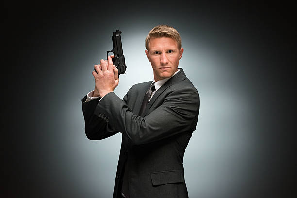 istock Spy in action with gun 510796276