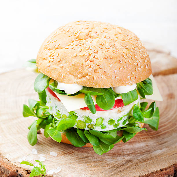 istock Vegetarian burger with egg and pea patty, fresh salad 510798328