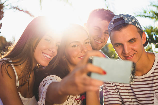 Group of friend having fun and taking selfies on a sunny day.