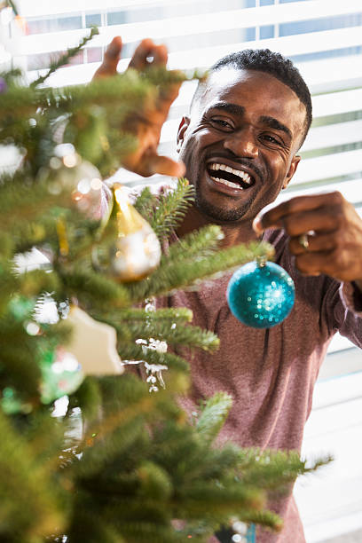 istock African American man with big smile decorating Christmas tree 510798931