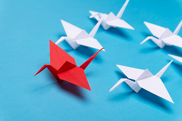 Leadership concept Traditional Japanese origami crane made of red and white paper origami cranes stock pictures, royalty-free photos & images