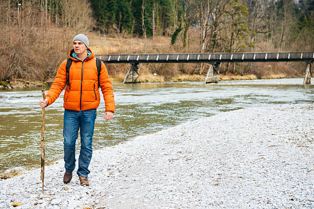 istock Explorer hiking in national park and finding directions near river 510801636
