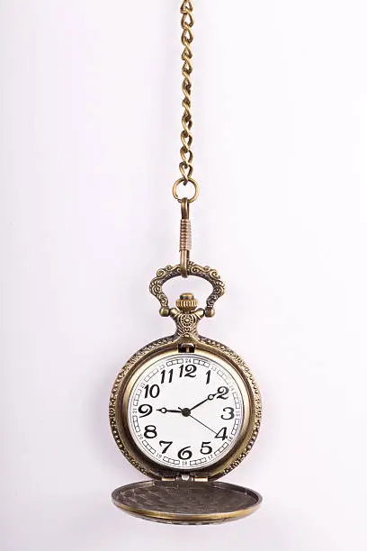 Close-up of a vintage pocket watch with chain representing the concept of time is money.