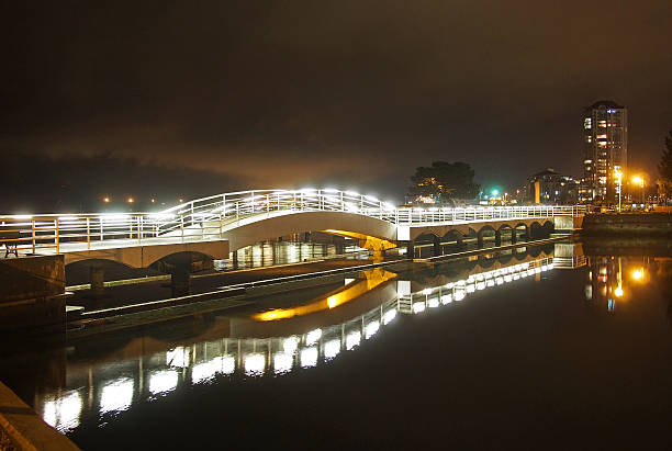 Paignton seafront and pier at night ith reflected lights on the sea and beach