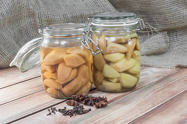 istock Two Preserved Pear Compote in Glass Jar on Wooden Table 510804258
