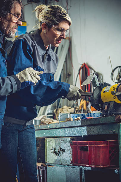 istock Young Woman Grinding Metal in Mechanical Workshop 510805720