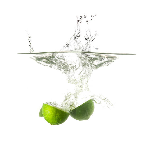 istock Limes splash on water, isolated. 510843350