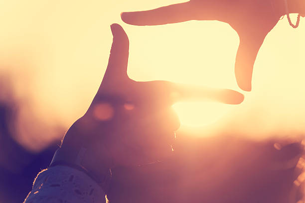 istock Fingers Framing the sun at sunset. 510844990