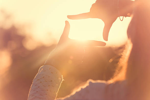 Fingers Framing the sun at sunset.
