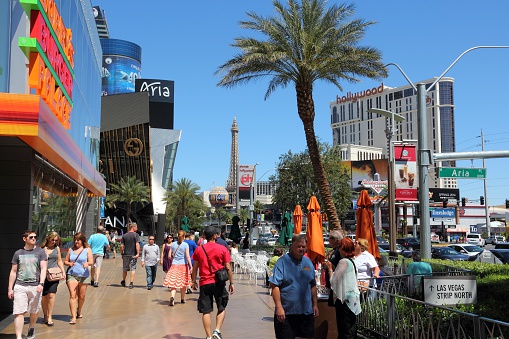 Las Vegas, United States - April 14, 2014: People visit the famous Strip in Las Vegas. 15 of 25 largest hotels in the world are located at the strip with more than 60 thousand rooms.