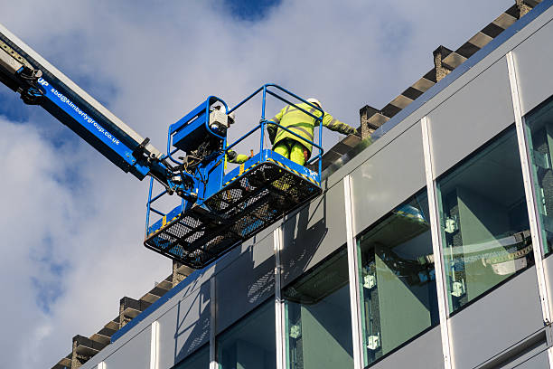 Two male construction workers working at height Nottingham, England - February 18, 2016: Two male construction workers working at height during building works on University Of Nottingham, University Park campus. nottinghamshire stock pictures, royalty-free photos & images