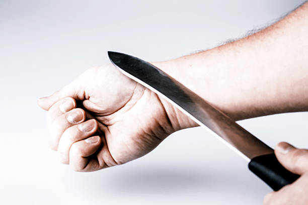 istock Close up of a suicidal man hand on isolated white 510849408