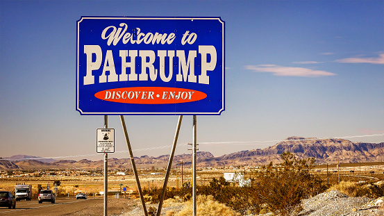 Pahrump, United States - February 17, 2016: Traffic passes the Welcome to Pahrump Nevada sign