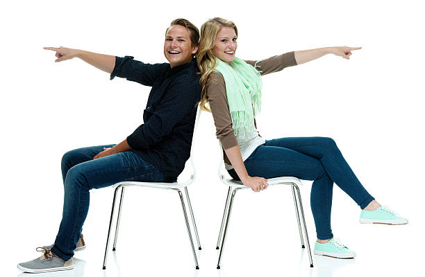 istock Happy couple sitting on chair and pointing 510849676