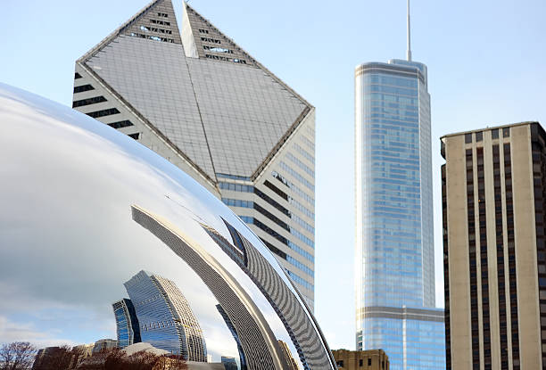 Chicago, IL, USA - April 23, 2015: Part of Cloud Gate and Chicago skyline. Cloud Gate is the artwork of Anish Kapoor as the famous landmark of Chicago in Millennium Park.