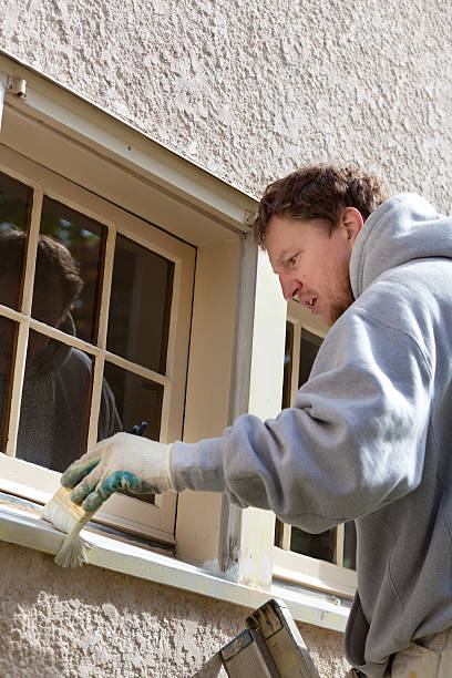 istock House Painter Working on Exterior Home Maintenance Improvement Painting Work 510853296