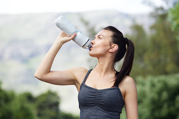 istock Fit young woman drinking water after workout 510854504