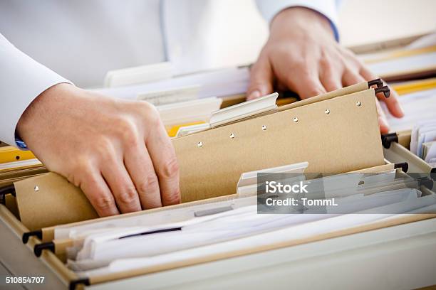 Filing In File Cabinet Stock Photo - Download Image Now - Filing Documents, Filing Cabinet, File Folder
