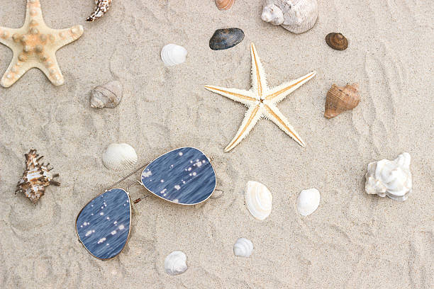 istock Starfish with glasses on a beach sand 510854780