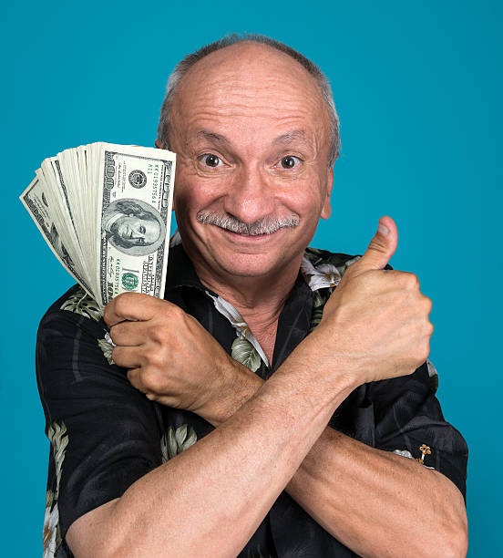 istock Lucky old man holding dollar bills 510855801